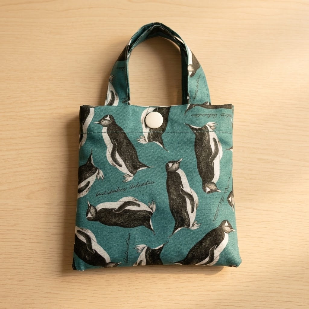 Foldaway penguin shopping bag made from recycled bottles